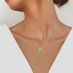 white gold peridot and diamond pendant on model